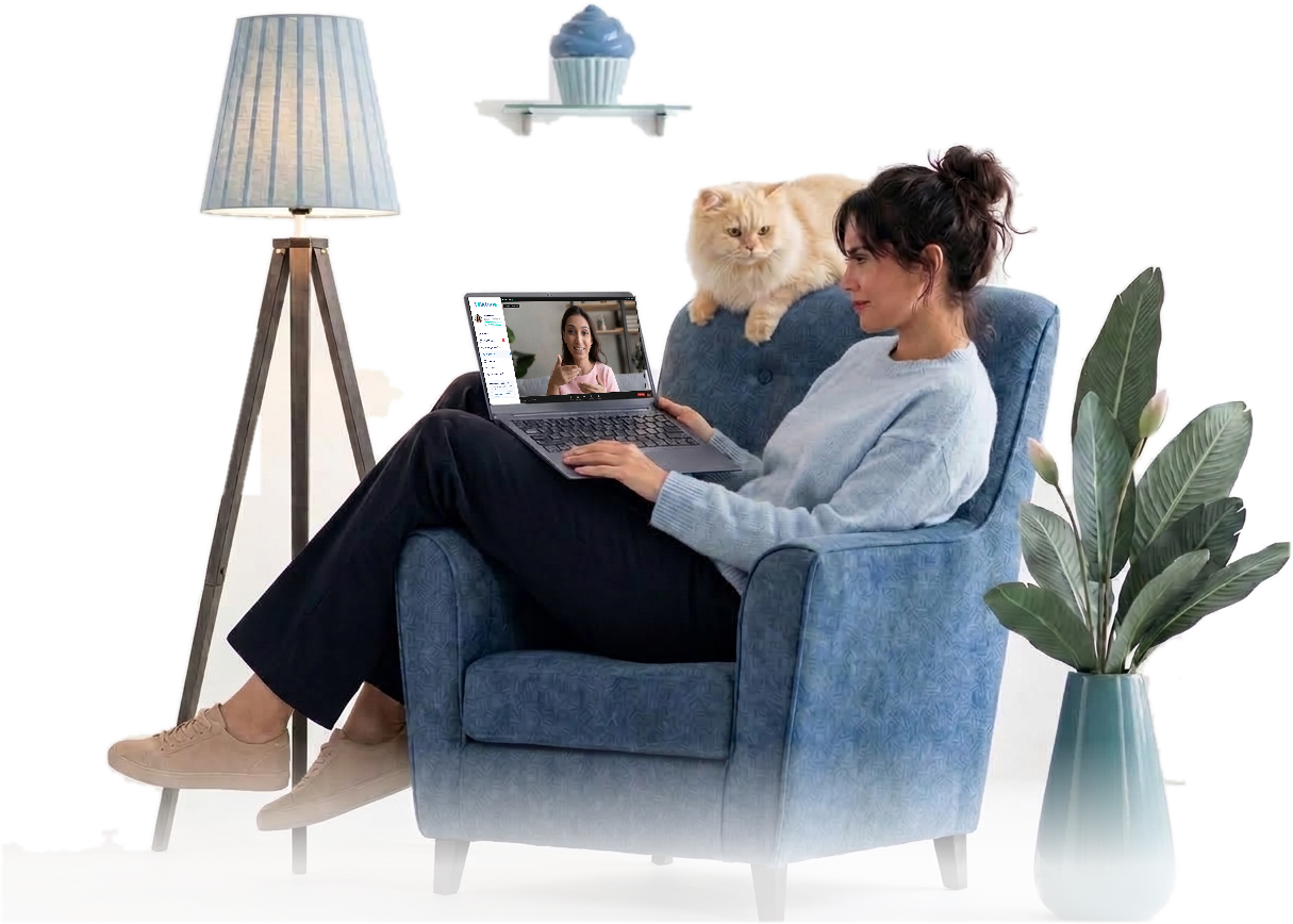 Woman speaking with her therapist online from an armchair at home